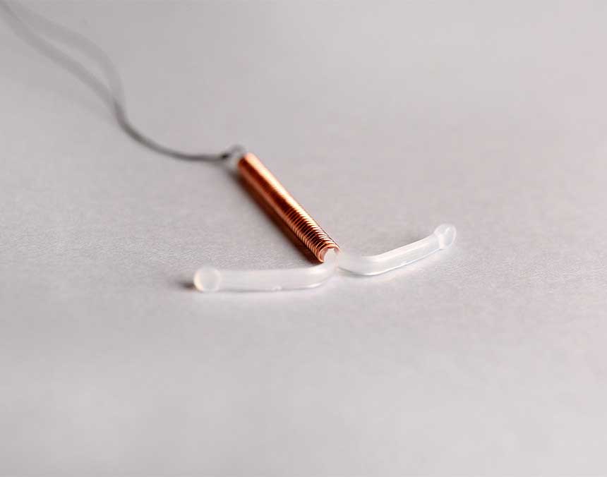 Dispositivo Intrauterino de cobre sobre una superficie blanca