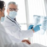 Médico cirujano le explica al paciente el tratamiento de lobectomía para su padecimiento pulmonar.