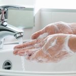 Persona mostrando cómo lavarse las manos para prevenir enfermedades